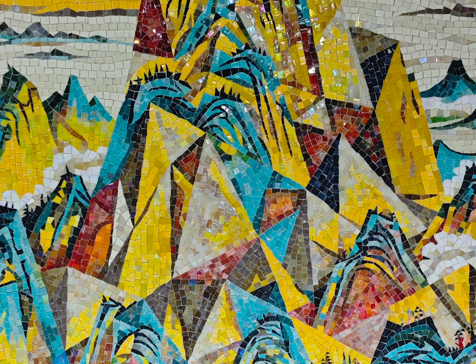Turquoise mountains and golden sky in a handmade landscape mosaic